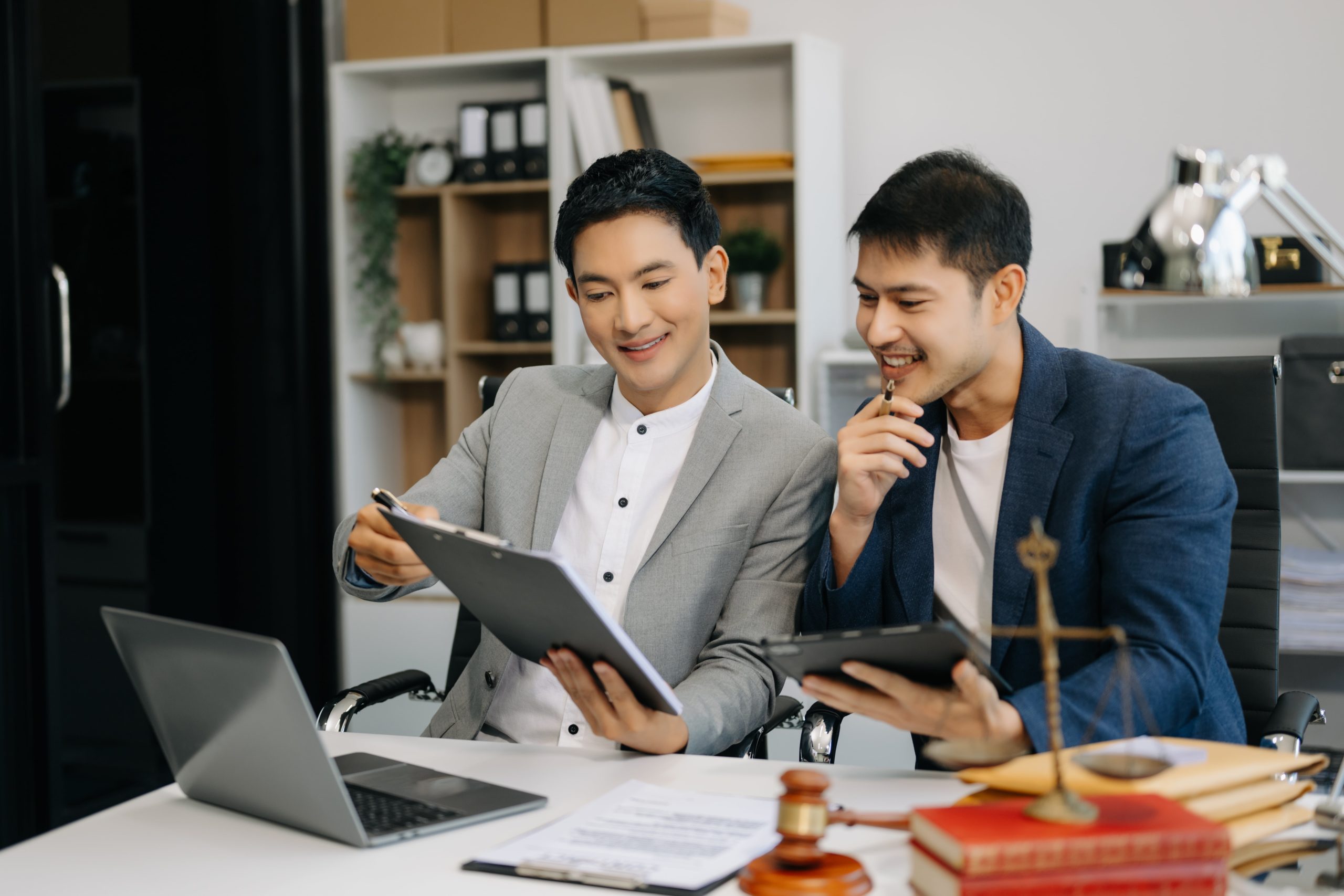 a couple of men looking at a tablet