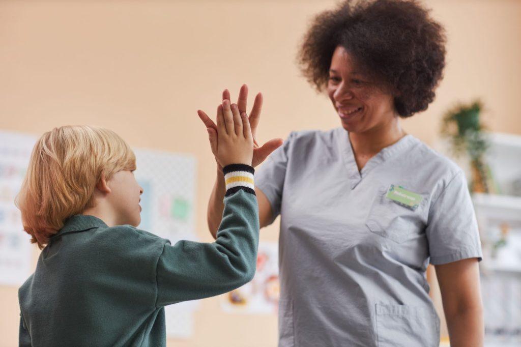 a woman and boy giving each other a high five