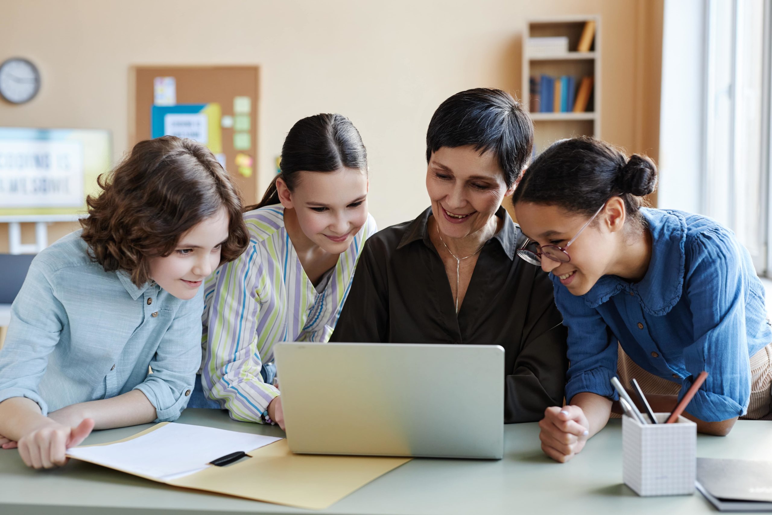 a group of people looking at a laptop