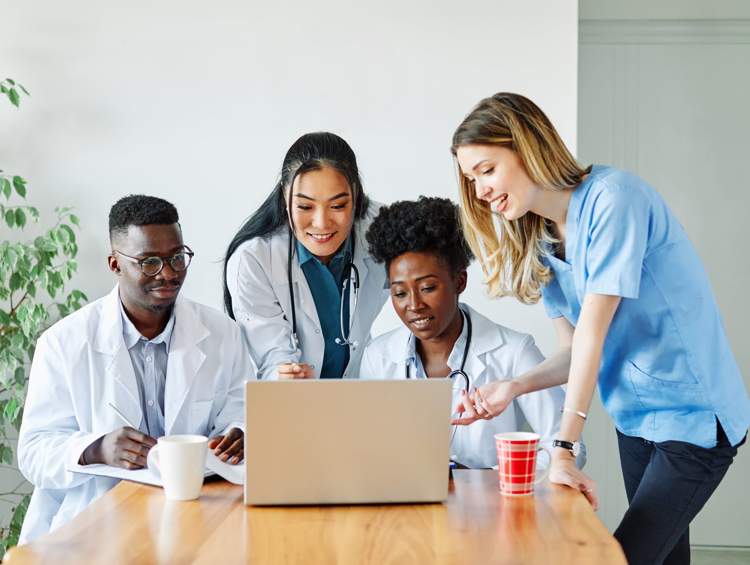 a group of people looking at a laptop