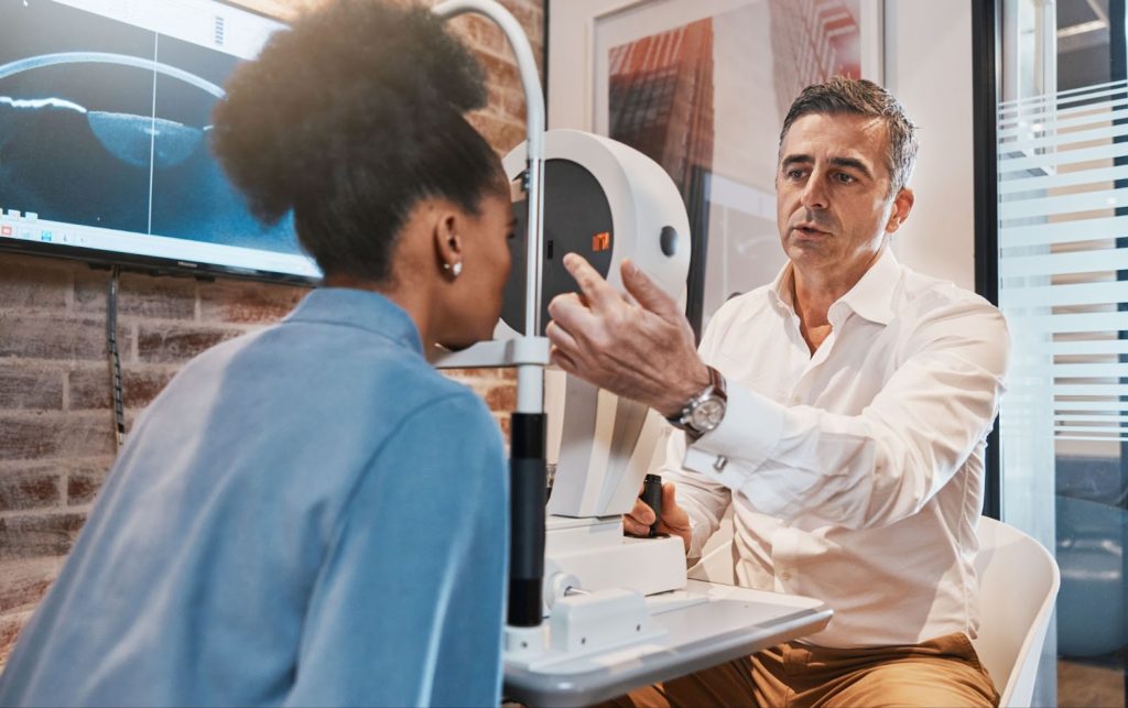 a man and woman looking at an eye test