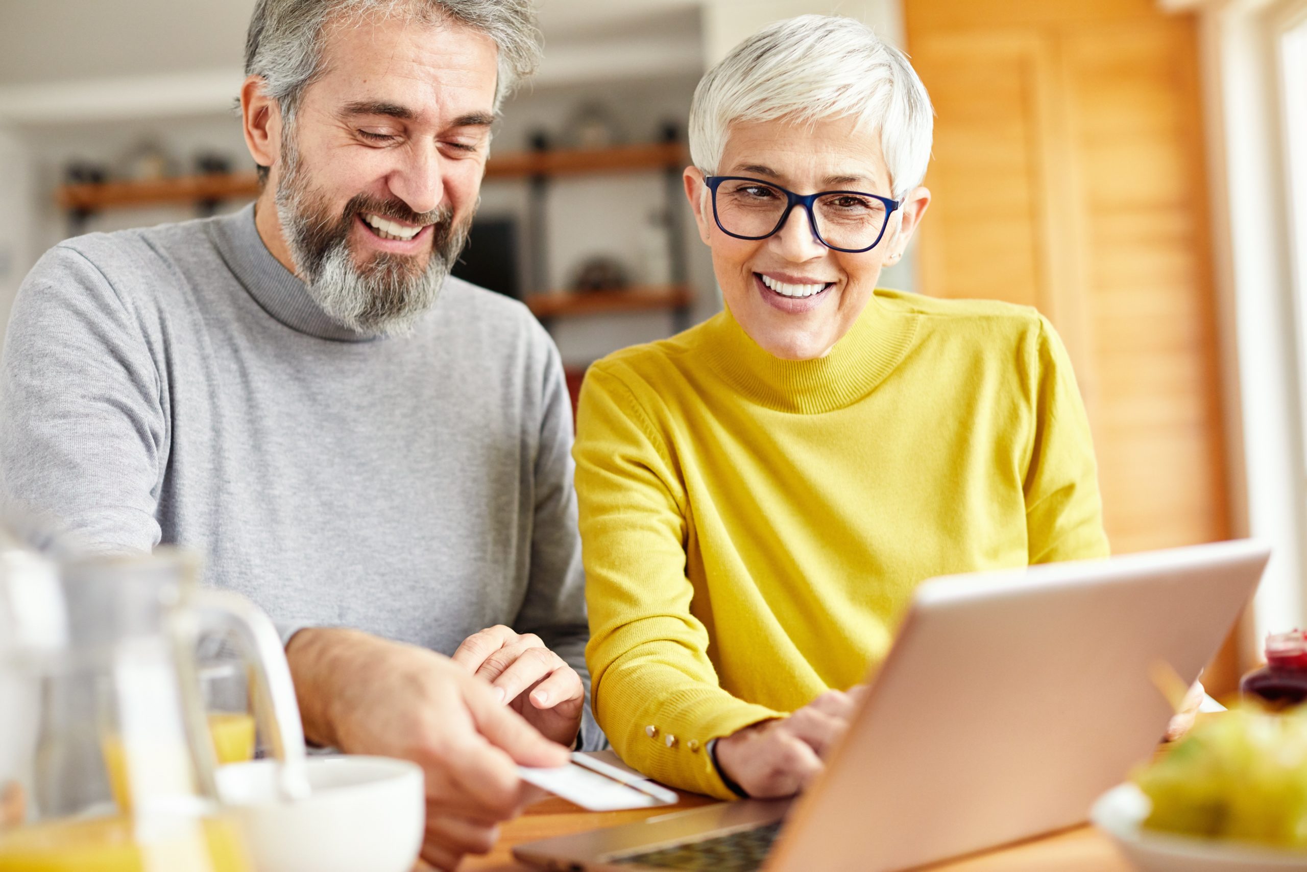 a man and woman looking at a laptop