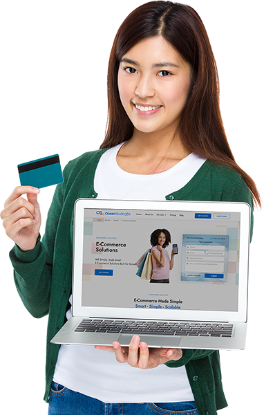 a woman holding a credit card and a laptop