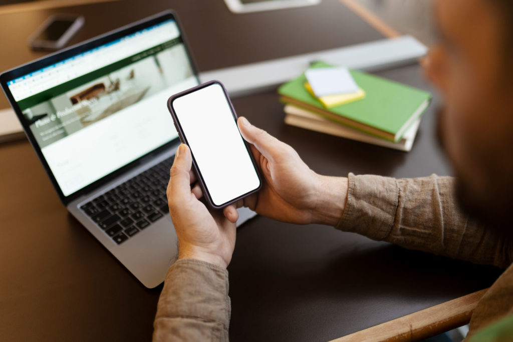 a person holding a phone with a blank screen