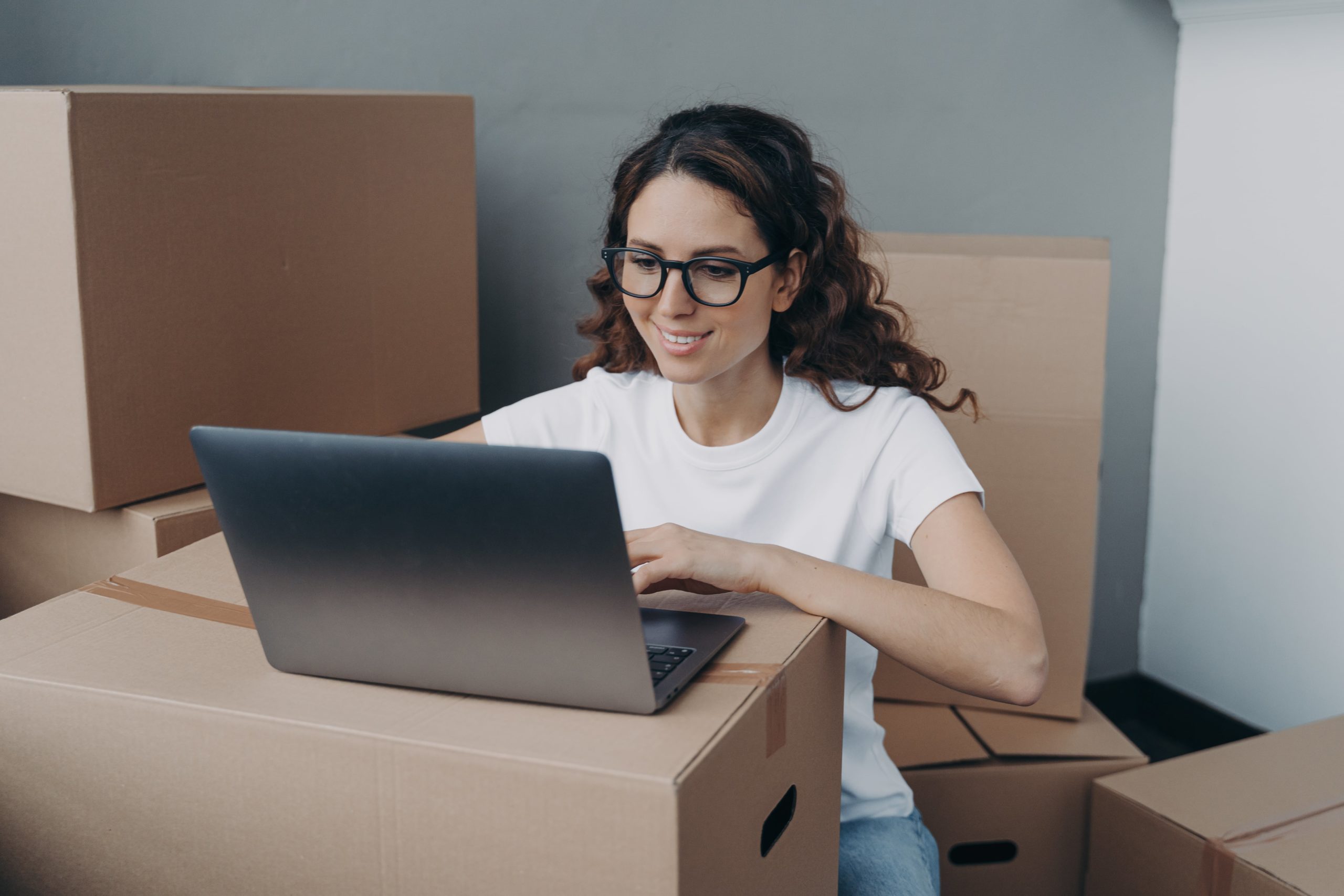 a woman sitting in front of a laptop