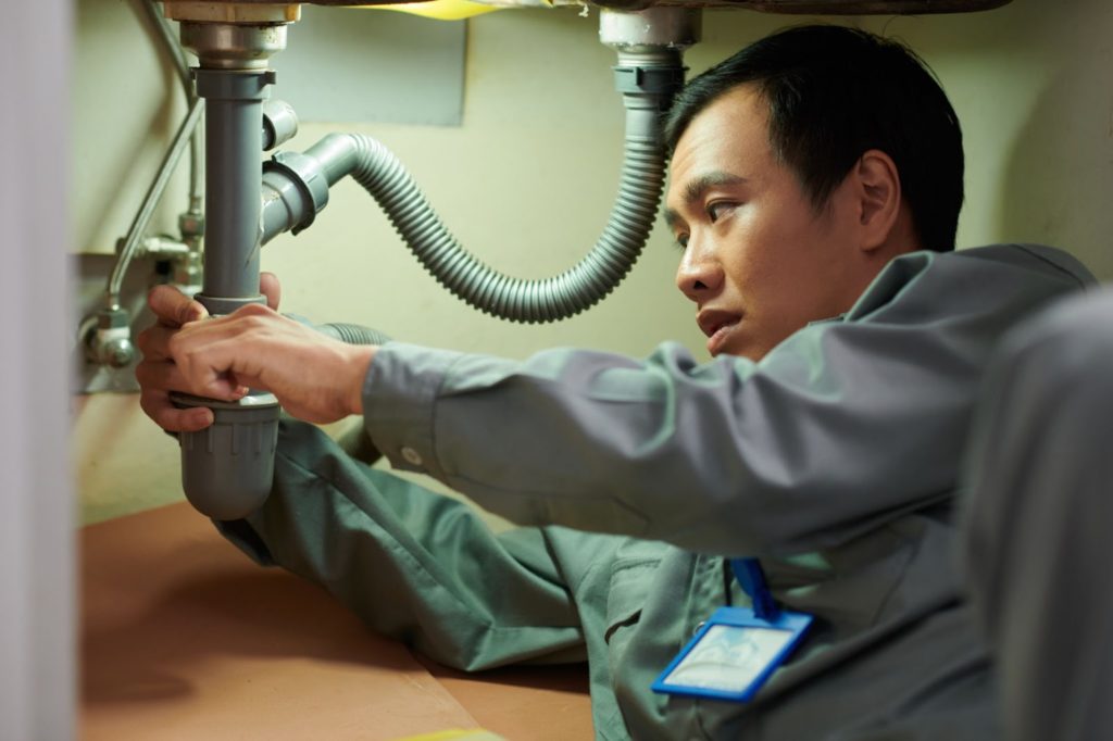 a man working under a sink