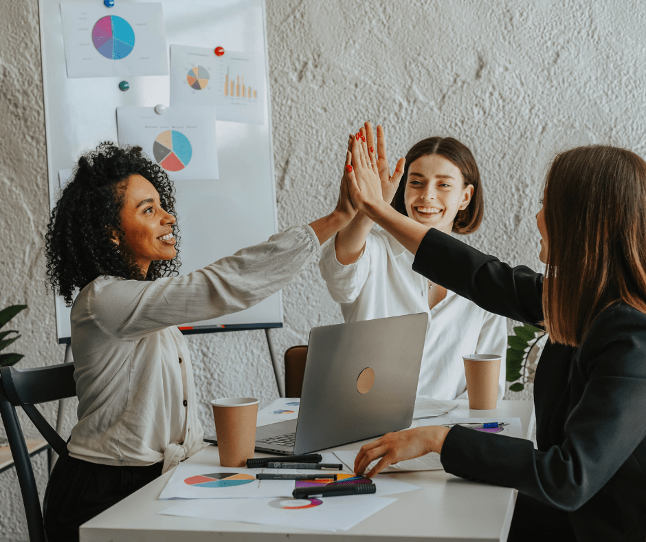 a group of women giving each other a high five