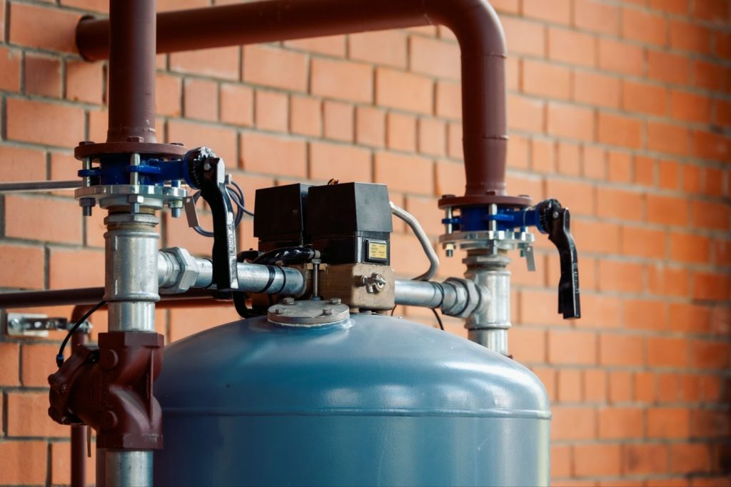 a blue cylinder with pipes and valves