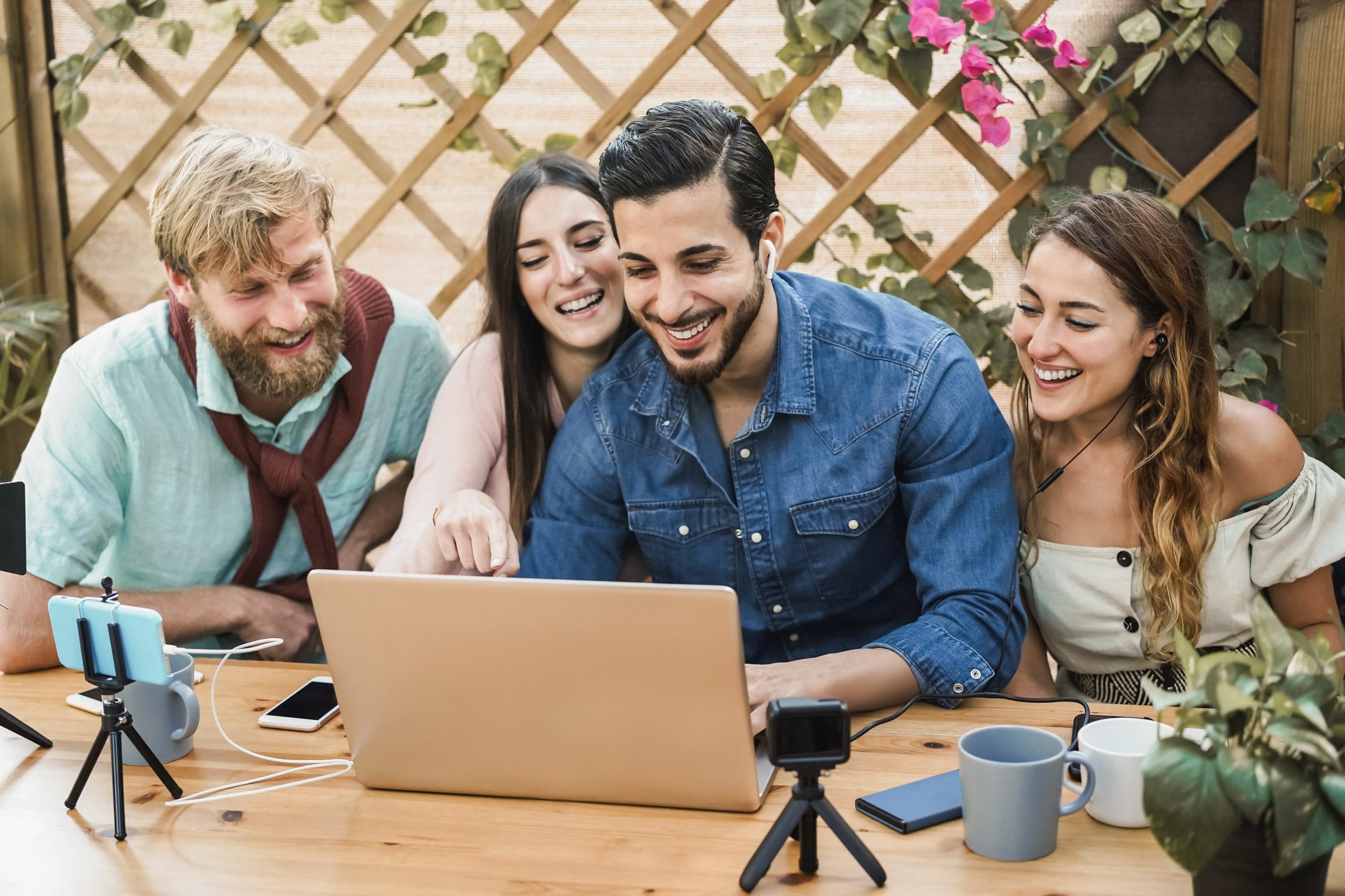 a group of people looking at a laptop