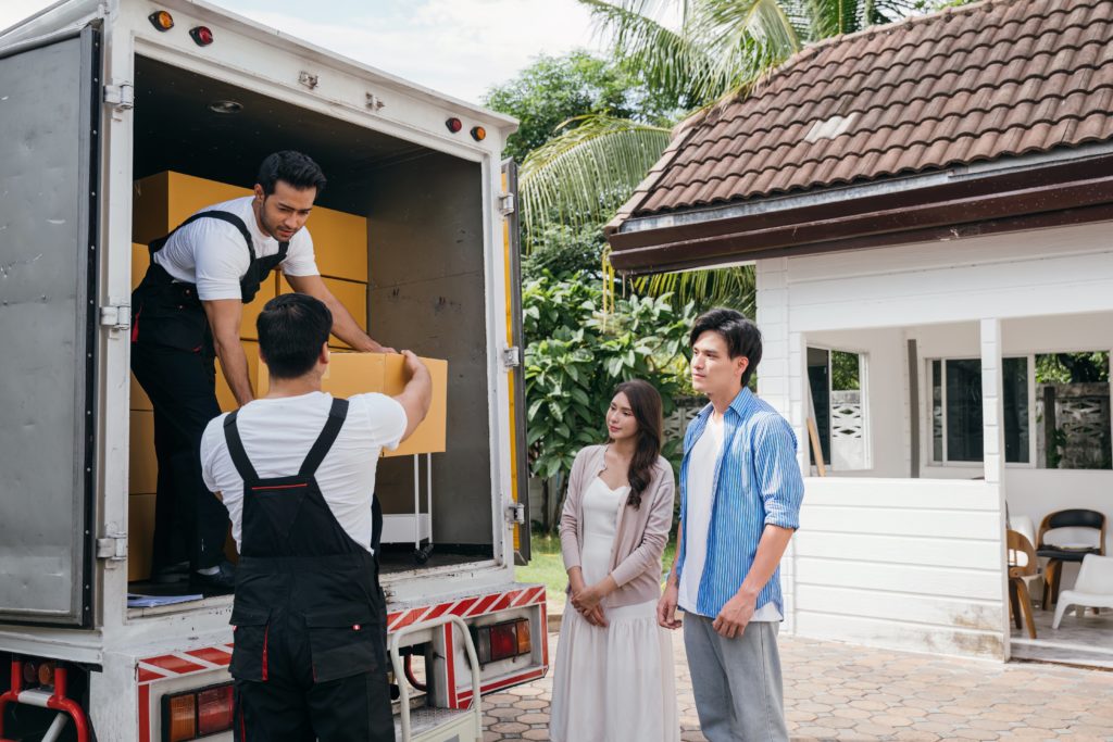 a man standing next to a couple of people in a truck