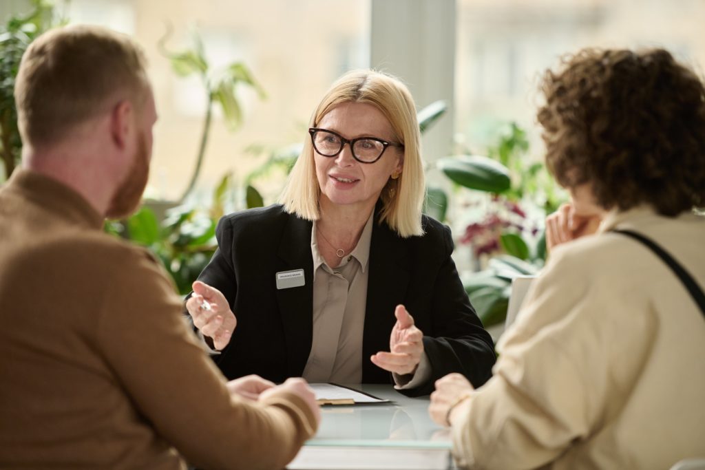 a woman talking to a group of people