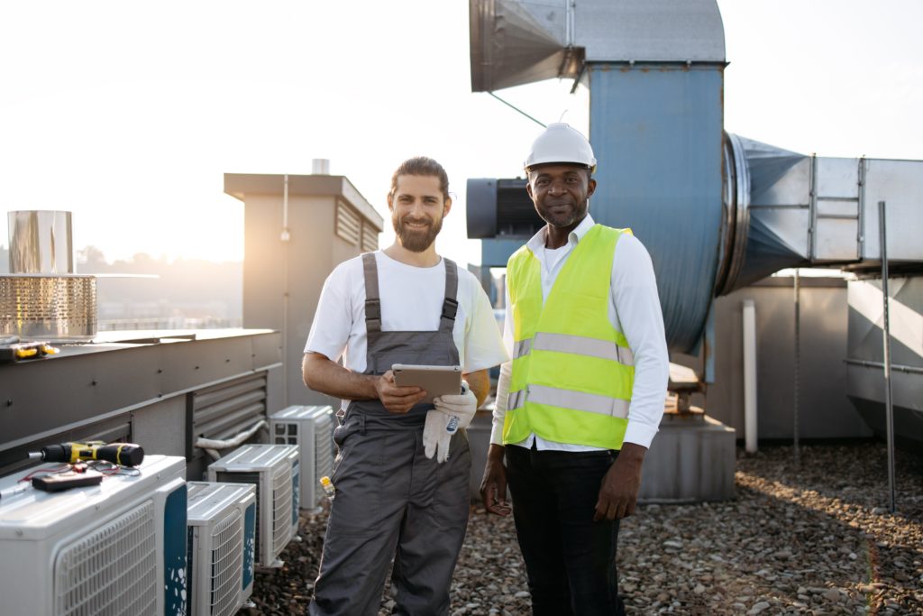 two men standing on a roof