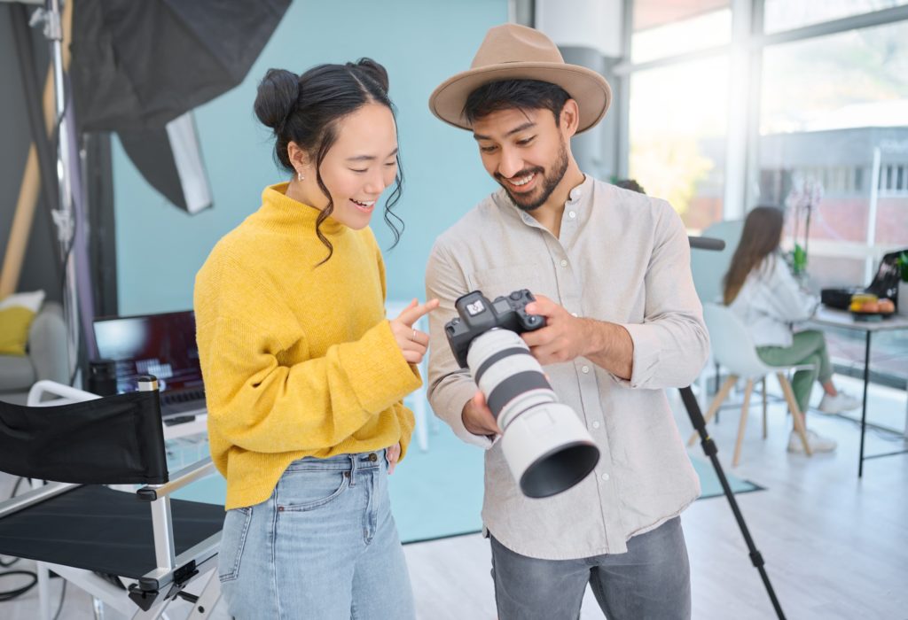 a man and woman looking at a camera