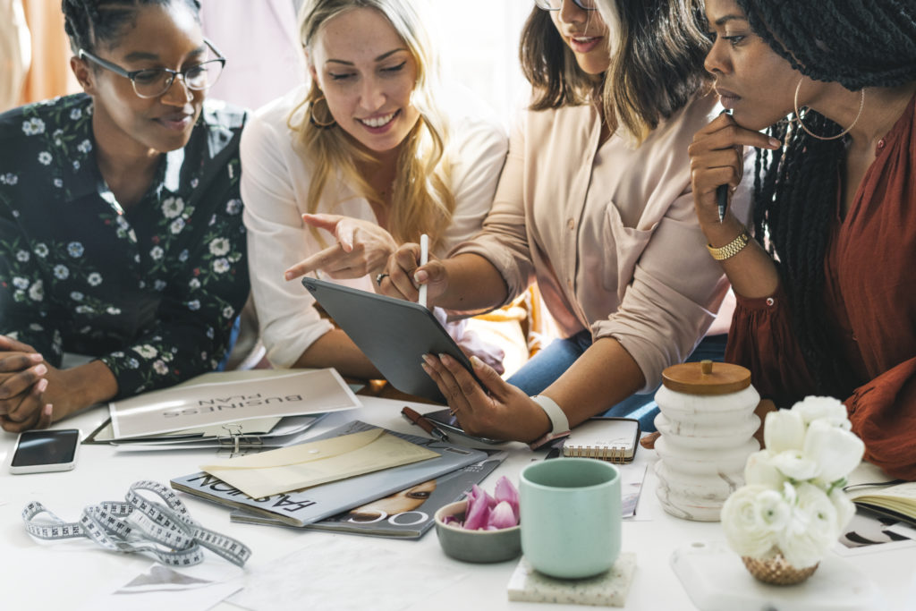 Fashion designers having a meeting using a digital tablet