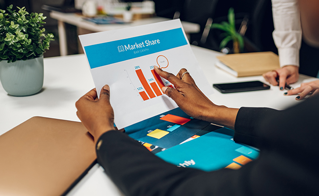 Close shot of a business colleagues discussing chart document used to accompany the company's monthly meeting, Business people discussing the company's annual sales report to the attendees.